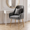 Fauteuil en velours cannelé gris anthracite devant une coiffeuse blanche